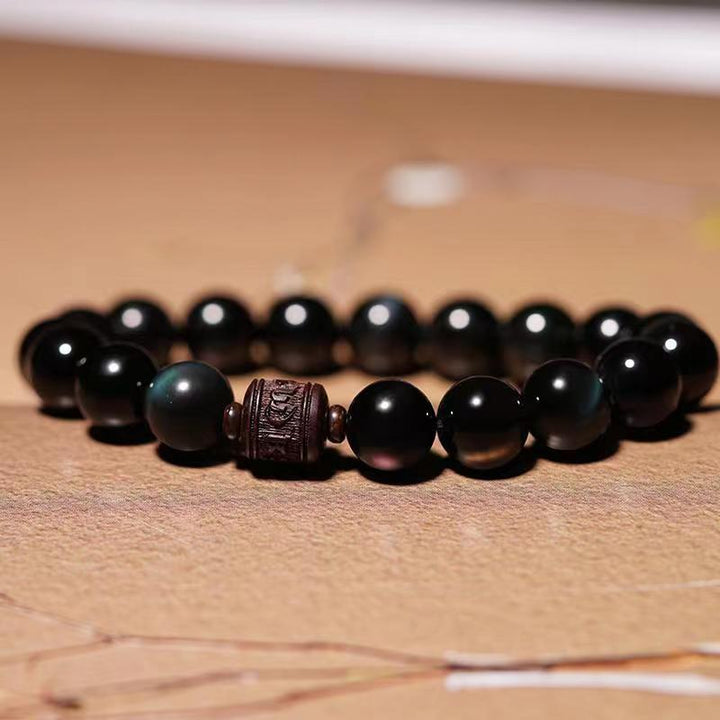 Schwarzes Obsidian Armband mit Om Mani Padme Hum Anhänger elegant.