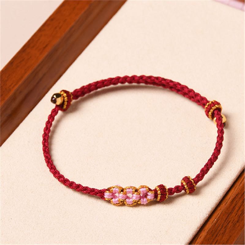 Armband Pfirsichblüte – Schutz rotes Seil goldene Perlen elegant