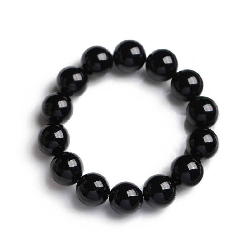 Armband Schwarzer Onyx – Glück mit glänzenden Perlen elastisch getragen