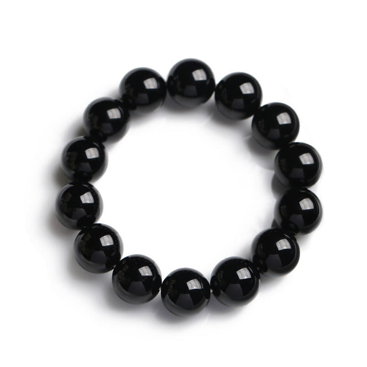 Armband Schwarzer Onyx – Glück mit glänzenden Perlen elastisch getragen
