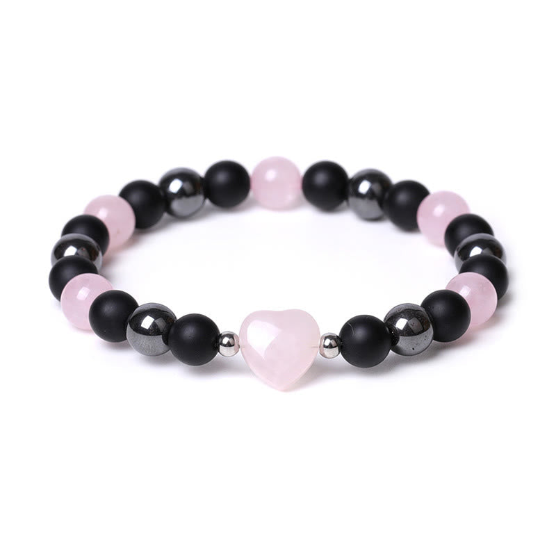 Armband mit schwarzem Onyx, rosa Quarz Herz und silbernen Perlen elegant.