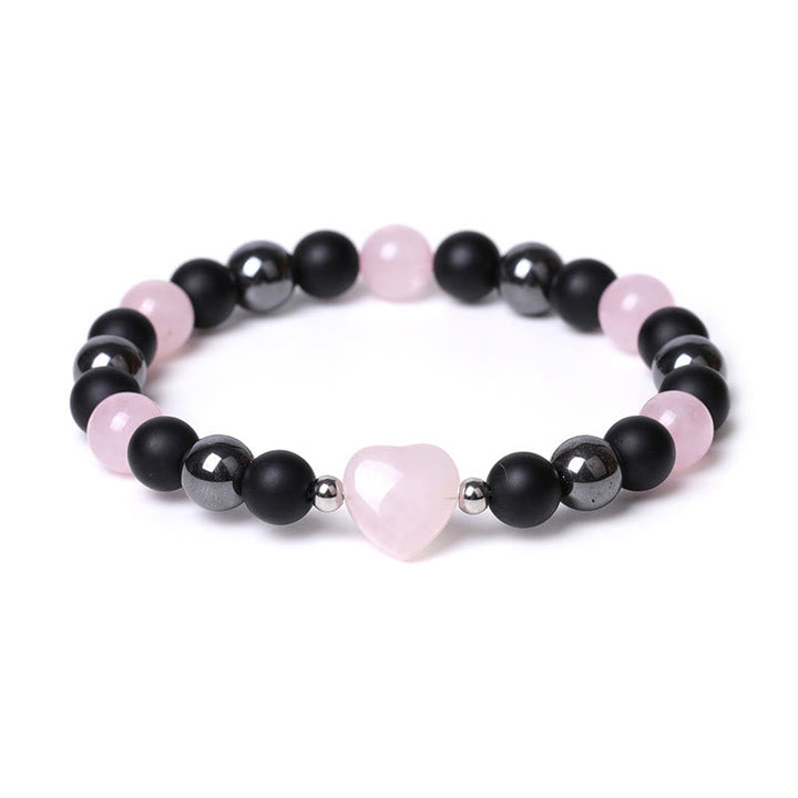 Armband mit schwarzem Onyx, rosa Quarz Herz und silbernen Perlen elegant.