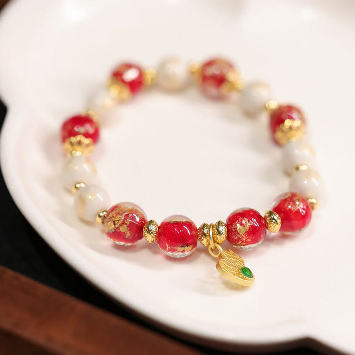 Armband Kürbis Wohlstand Glück Energie rote Perlen Gold weiß elegant