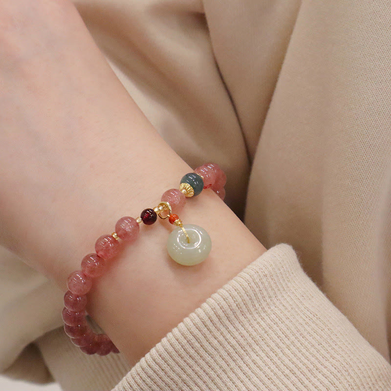 Armband Erdbeerquarz Jade am Handgelenk mit Anhänger elegant getragen