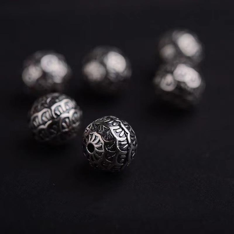Armband Lavastein – Heilung mit ornamentalen silbernen Perlen dunkel