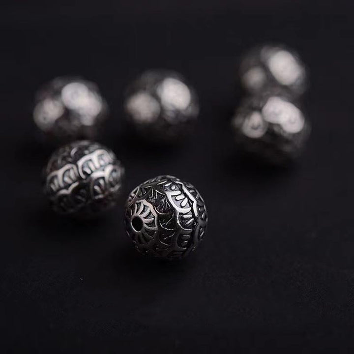 Armband Lavastein – Heilung mit ornamentalen silbernen Perlen dunkel