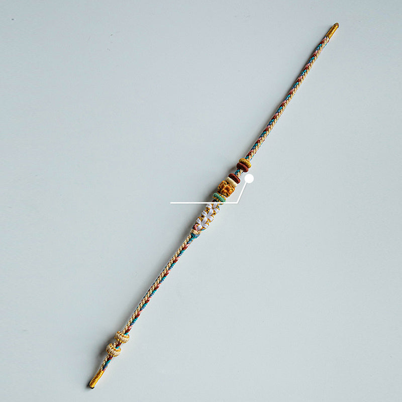 Armband Pfirsichblüte mit Kupferelementen und Schnur geknüpft.