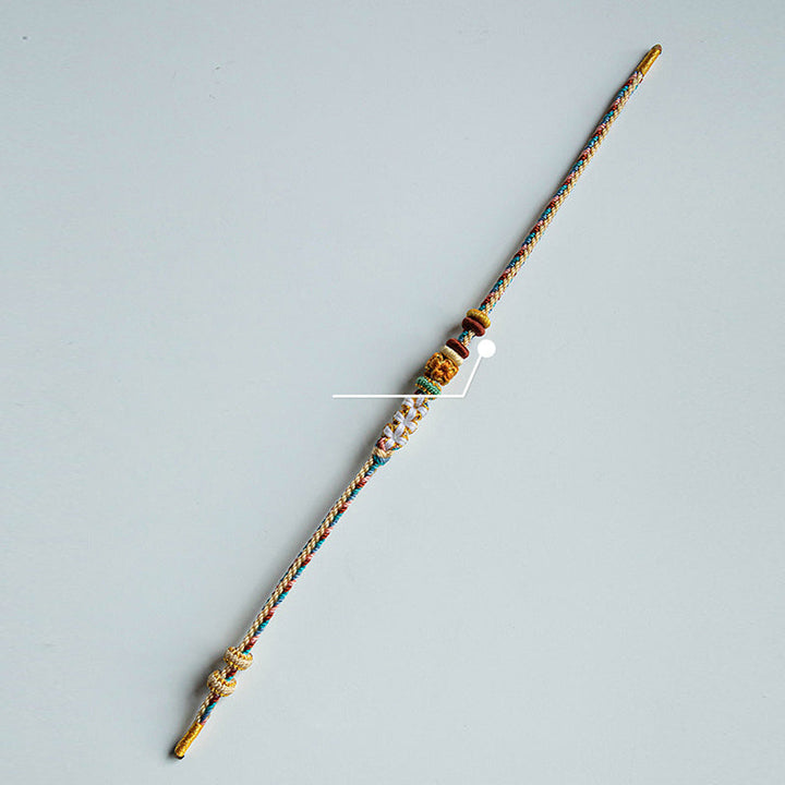 Armband Pfirsichblüte mit Kupferelementen und Schnur geknüpft.