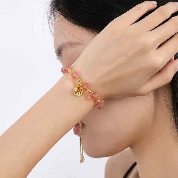 Armband Erdbeerquarz Fu-Zeichen Energie goldfarben elastisch Naturstein