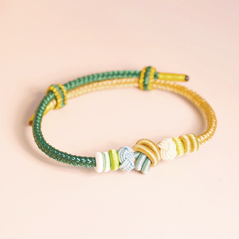 Armband – Glück & Frieden mit grünen und gelben Schnüren Perlen.