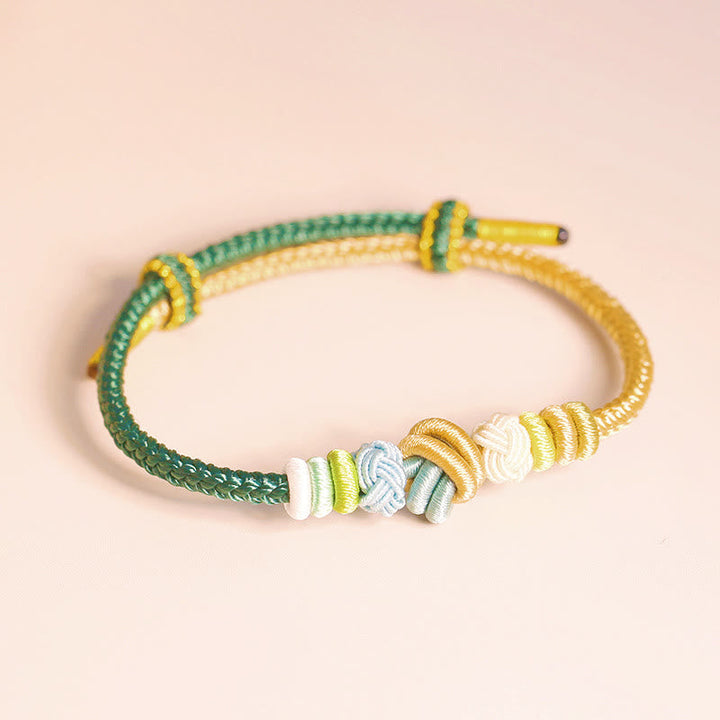 Armband – Glück & Frieden mit grünen und gelben Schnüren Perlen.