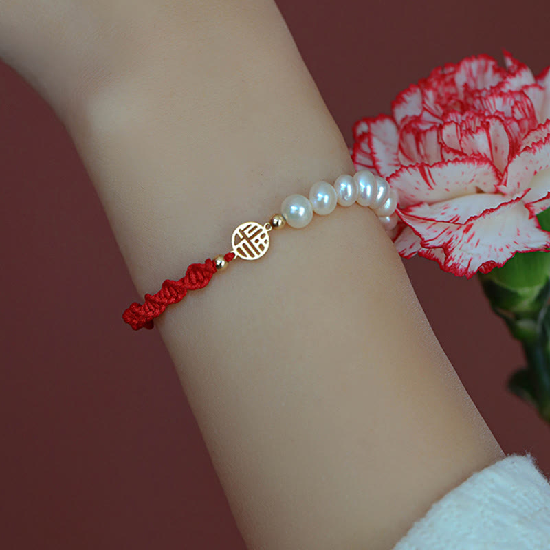 Armband Perle – Schutz & Glück mit rotem Seidenfaden und Perlen.