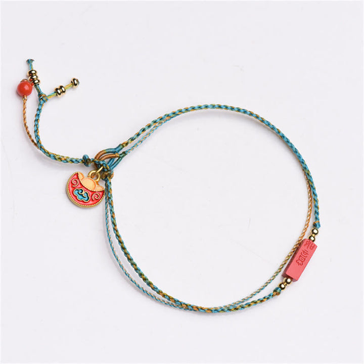 Armband Zinnober – Segen & Balance buntes Seidenarmband mit Glöckchen Anhänger