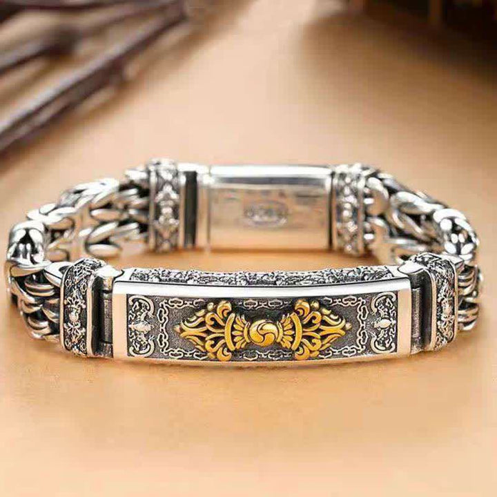 Silbernes Armband mit goldenem Ornament am Handgelenk getragen