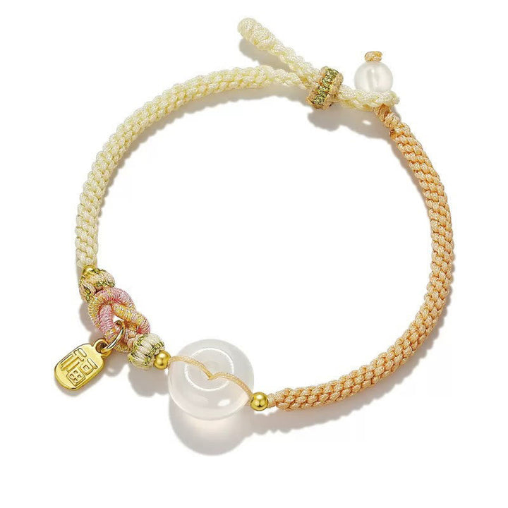 Armband Achat mit weißen Steinen und goldenen Elementen elegant.