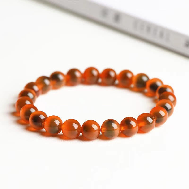 Armband Achat – Stärke & Harmonie, orangefarbene Perlen elastisch geflochten.