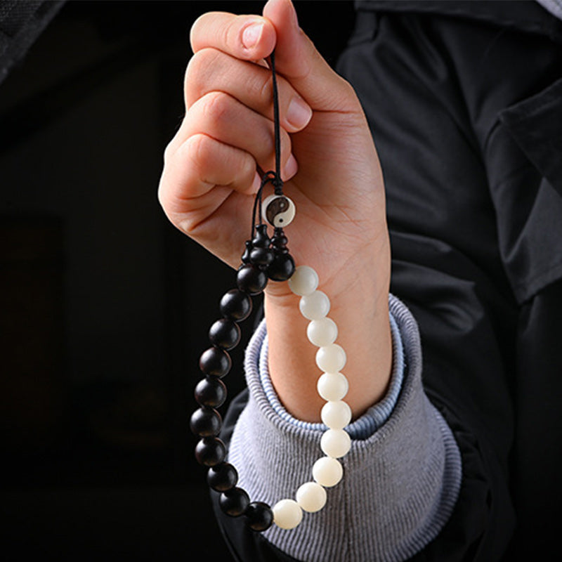 Armband Ebenholz – Schutz mit schwarzen und weißen Perlen Yin Yang.