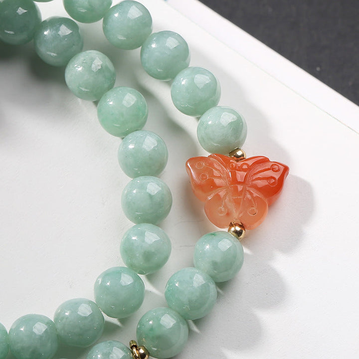 Jade Armband mit orange Schmetterling Anhänger Glück Fülle elegante Perlen.