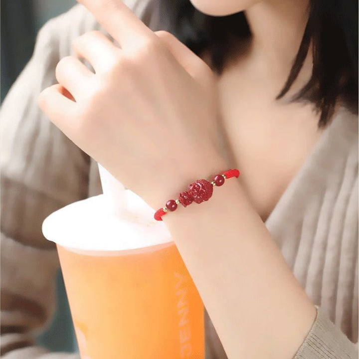 Rotes Armband Zinnober Chinesisches Tierkreis – Segen am Handgelenk getragen