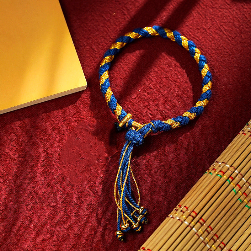 Blau-goldenes Drachen-Armband Glück Wohlstand Energie auf rotem Stoff.