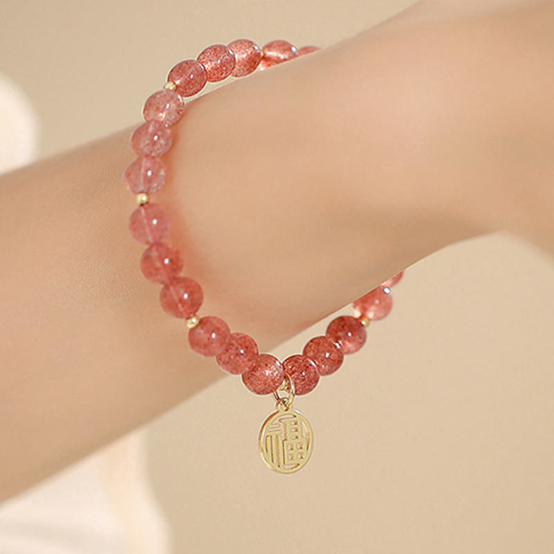 Armband Erdbeerquarz Fu-Zeichen Heilung, rosa Perlen elegant am Handgelenk