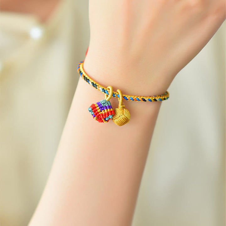 Buntes Glück Armband mit Zongzi und goldenem Anhänger getragen