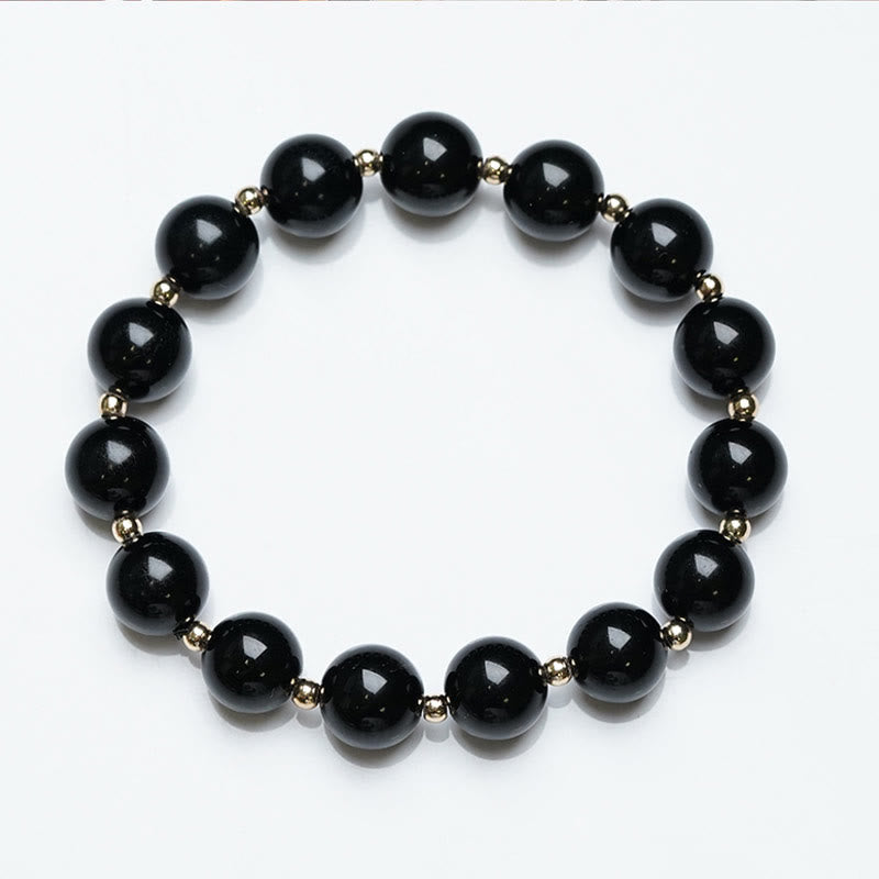 Armband Schwarzer Onyx – Schutz mit goldenen Perlen elegant gestaltet