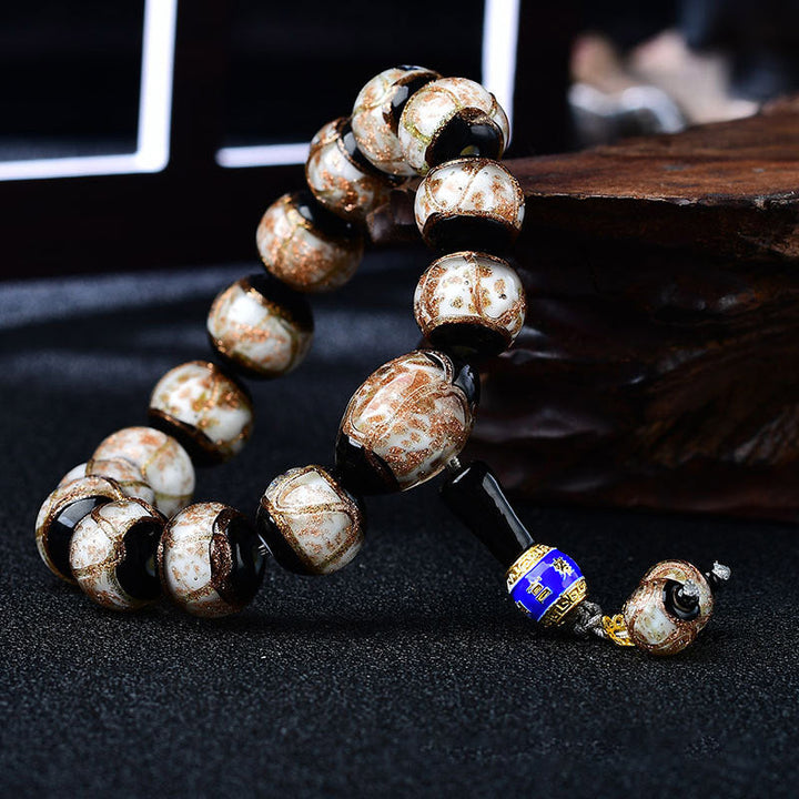 Armband Achat Drachen – Heilung mit braunen Natursteinen und blauem Akzent.