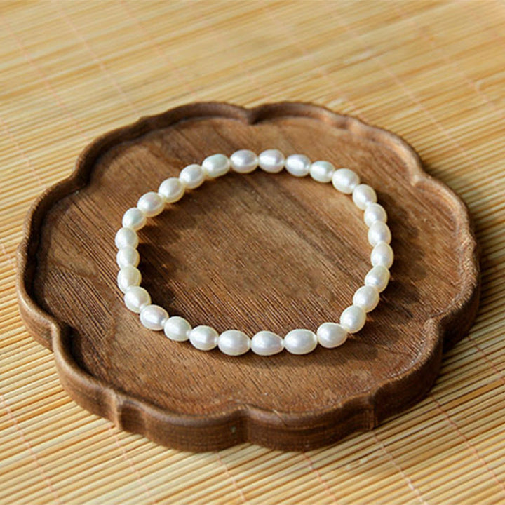 Armband Perle – Heilung weiße Perlen elastisch auf Holzschale