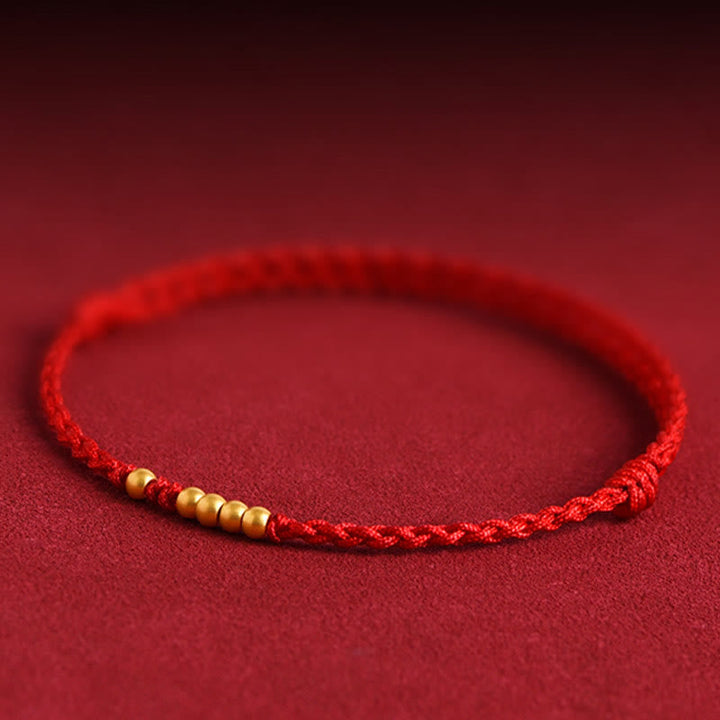 Rotes Armband mit goldenen Perlen Schutz Glück elastisch Schnur