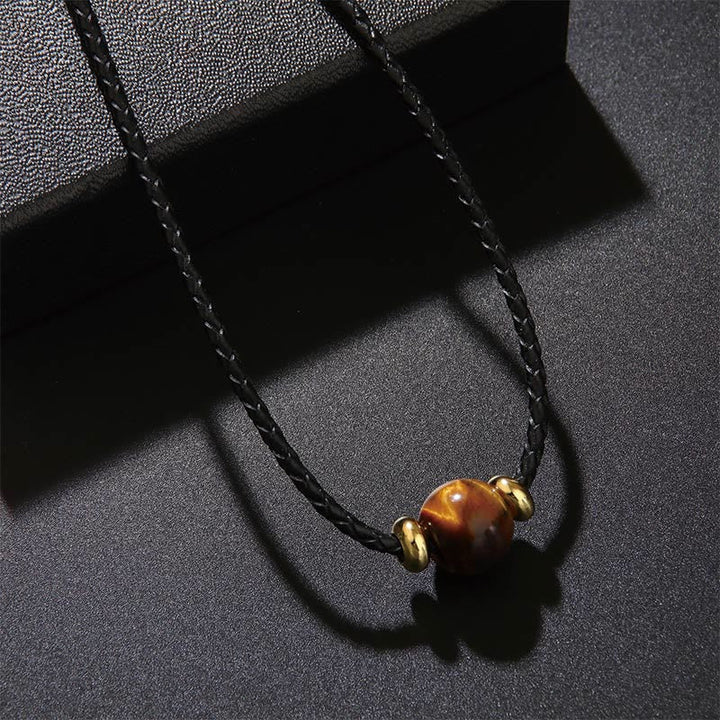 Tigerauge Kette mit schwarzer Schnur Schutzknoten goldene Perlen Naturstein