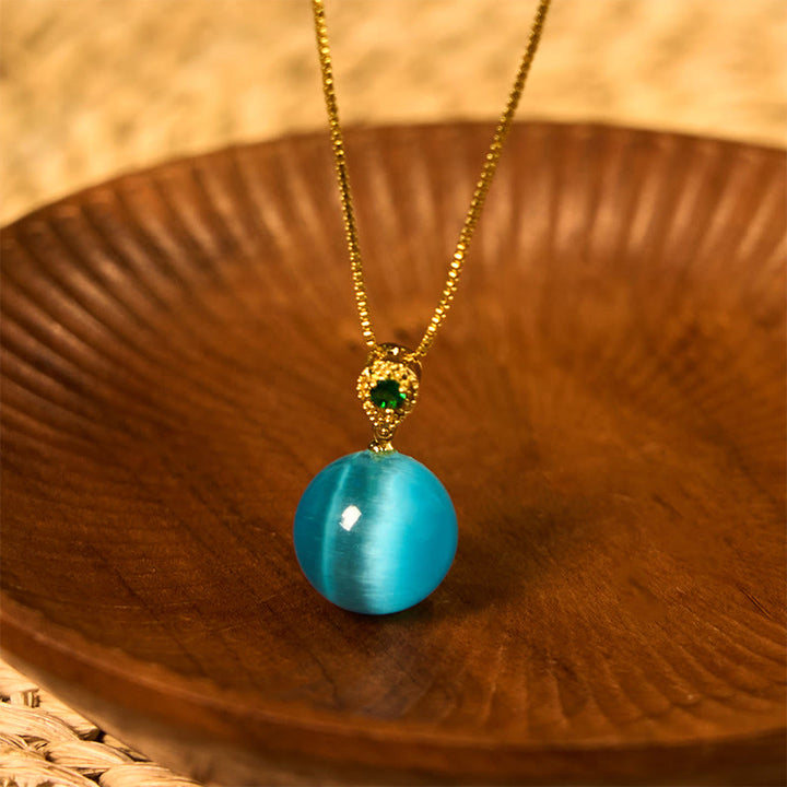 Elegante goldene Kette mit blauer Katzenauge Buddha-Kugel Anhänger