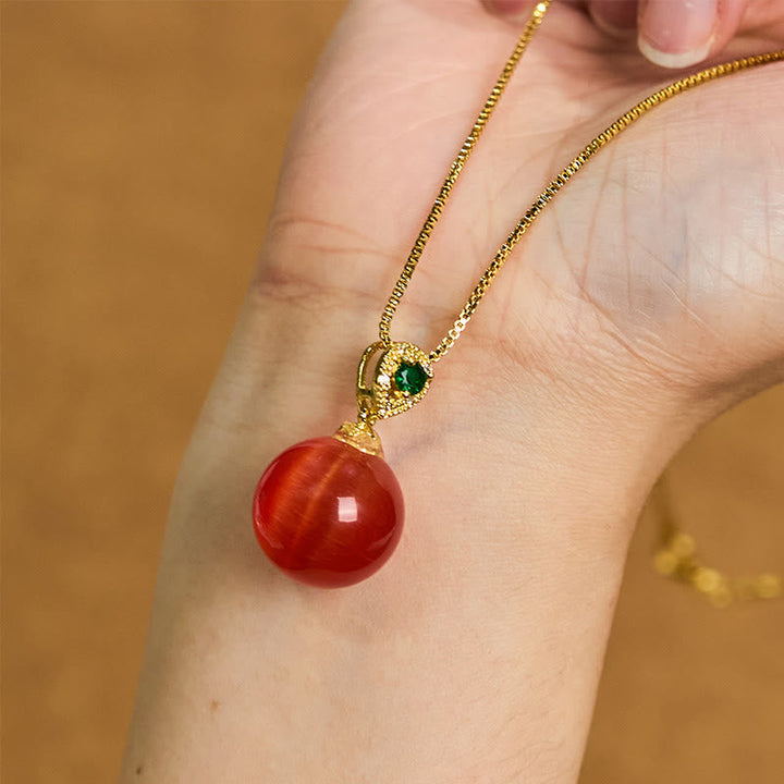 Goldene Kette mit roter Katzenauge Buddha-Kugel und grünem Anhänger Naturstein
