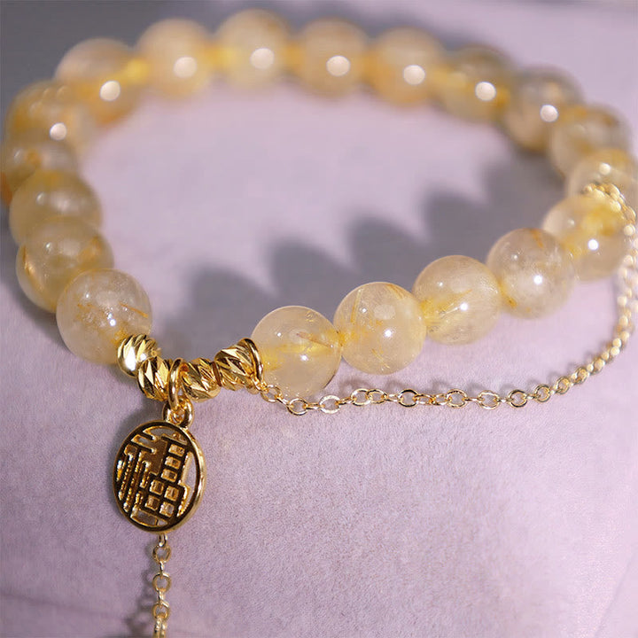 Citrin Armband mit Fu-Zeichen Anhänger Gold elastisch Naturstein