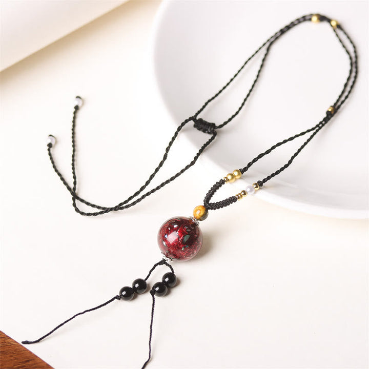 Schwarze Ebenholz Kette roter Buddha Stein Anhänger Perlmutt Frieden