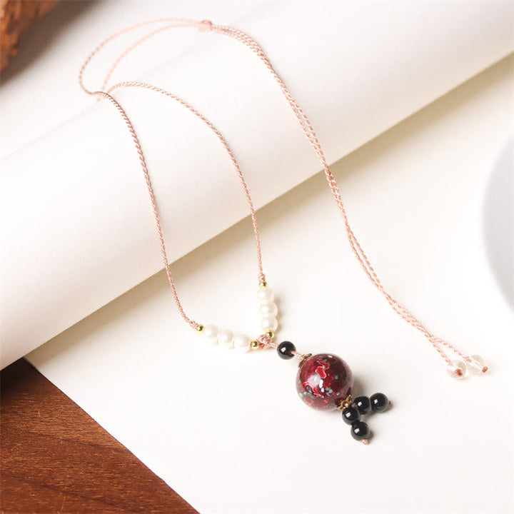 Kette Ebenholz Perlmutt Buddha mit roten Steinen und Perlen elegant