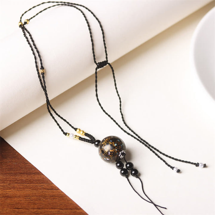 Schwarze Kette Ebenholz Buddha-Anhänger Perlmutt elegante Balance Design