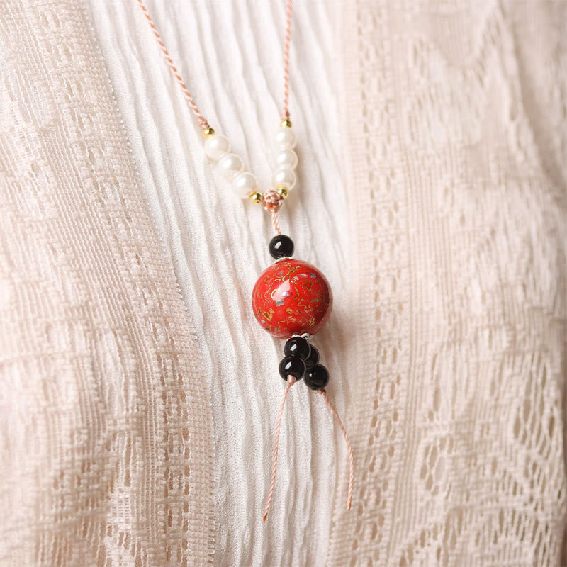 Ebenholz Perlmutt Kette Balance Buddha Anhänger mit rotem Mittelstein