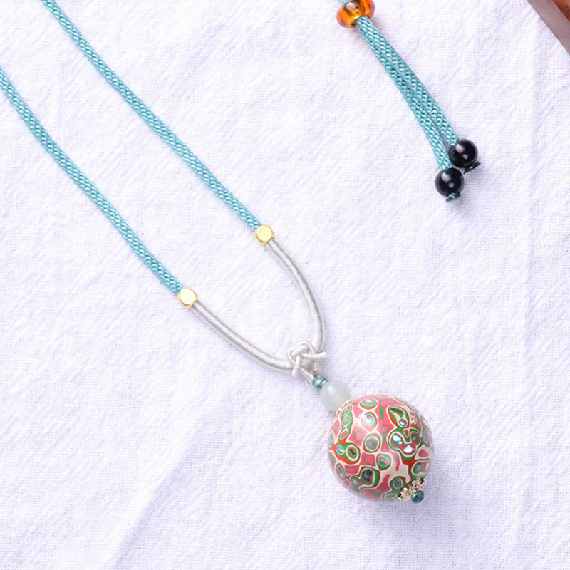 Ebenholz Kette mit buntem Buddha Anhänger türkis Schnur