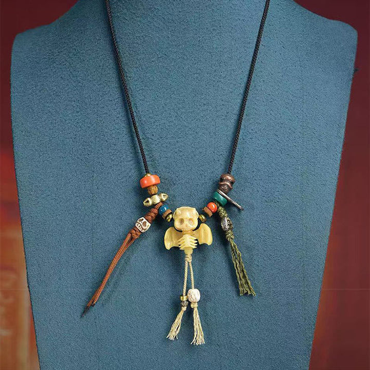 Schwarze Kette mit Schädel Anhänger orange Perlen Schnur Tibet