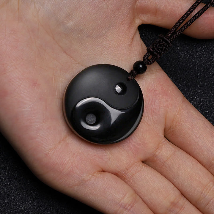 Obsidian Yin Yang Kette Schutz schwarzer Naturstein Anhänger in Hand