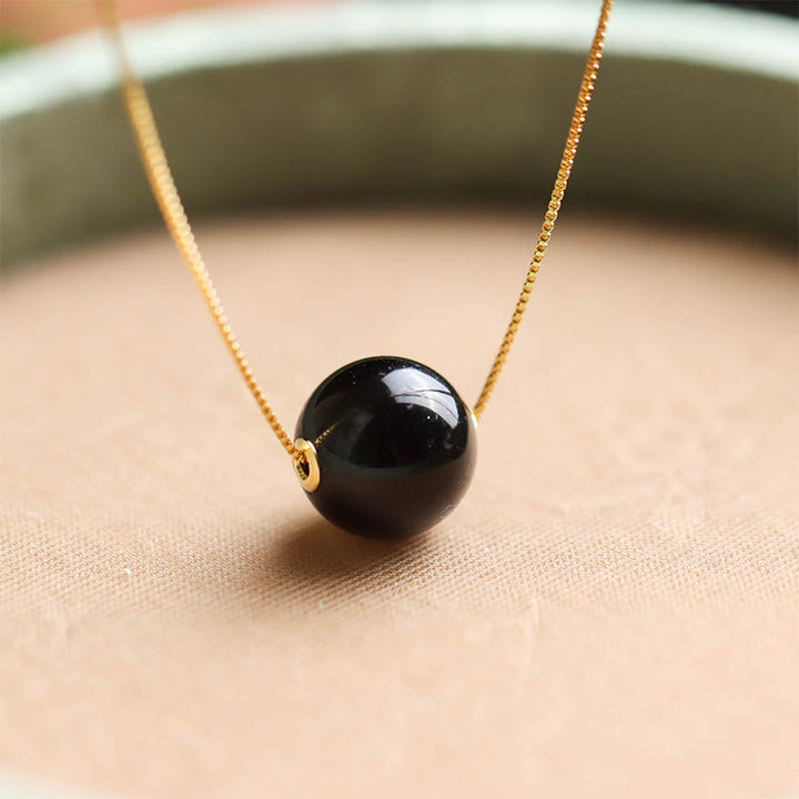 Schwarze Obsidian Kugelperle an goldener Kette Bernstein 925er Silber