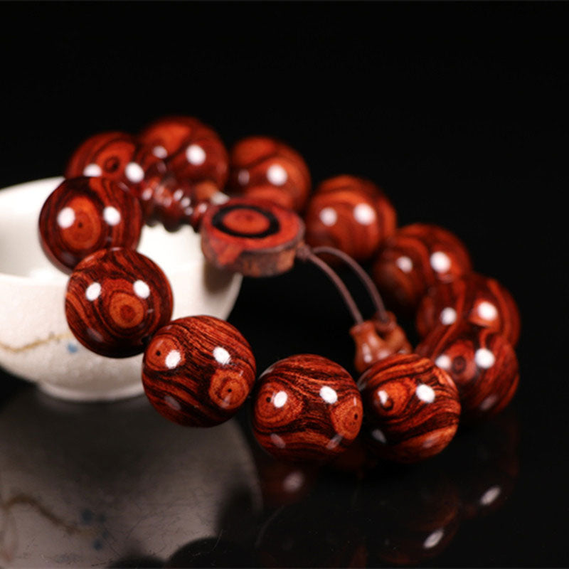 Armband Rosenholz mit weißen Einlagen auf weißer Schale dunkel