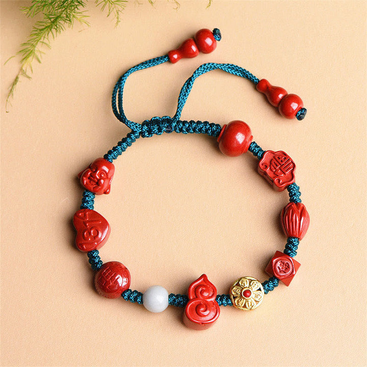 Rotes Zinnober Armband mit blauer Kordel und spirituellen Perlen Segen.