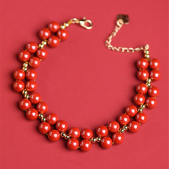 Armband Zinnober – Segen Harmonie rote Perlen Goldakzente elegantes Design.