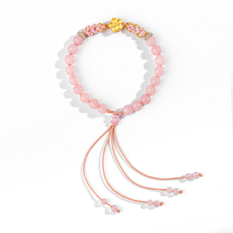 Rosaquarz Armband mit goldenem Blütenanhänger und Quastendeko elastisch