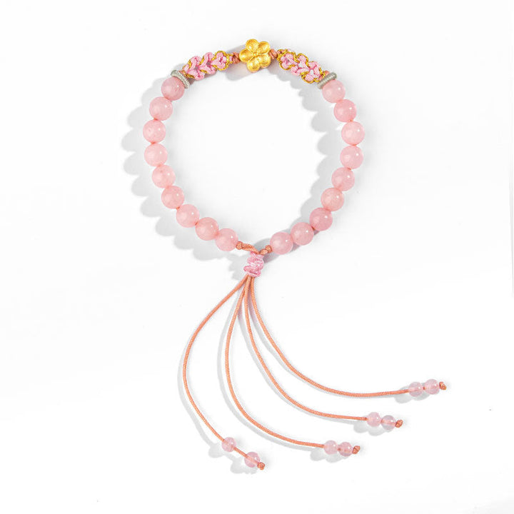 Rosaquarz Armband mit goldenem Blütenanhänger und Quastendeko elastisch