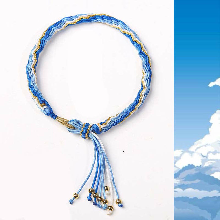 Blaues Samsara Knot Armband mit goldenen Elementen und Quasten Flachlage