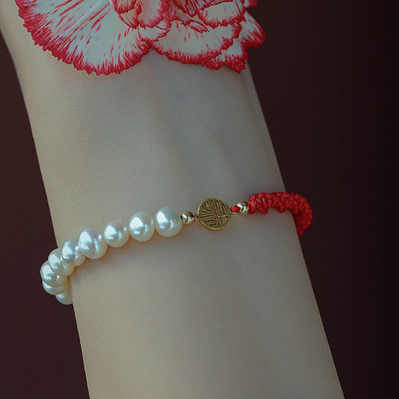 Armband Perle – Schutz & Glück mit weißen Perlen und roter Schnur getragen