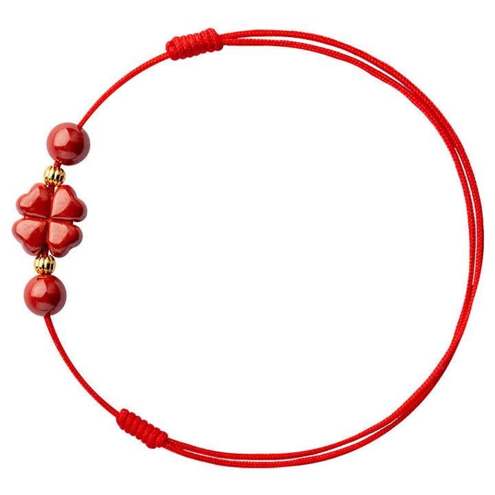 Rotes Armband Zinnober Kleeblatt mit Goldakzenten Flachlage Ansicht